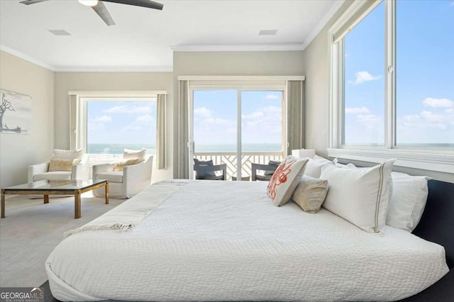 bedroom featuring access to outside, crown molding, multiple windows, and a water view