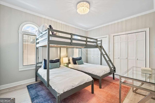 bedroom featuring ornamental molding, light wood finished floors, and multiple windows