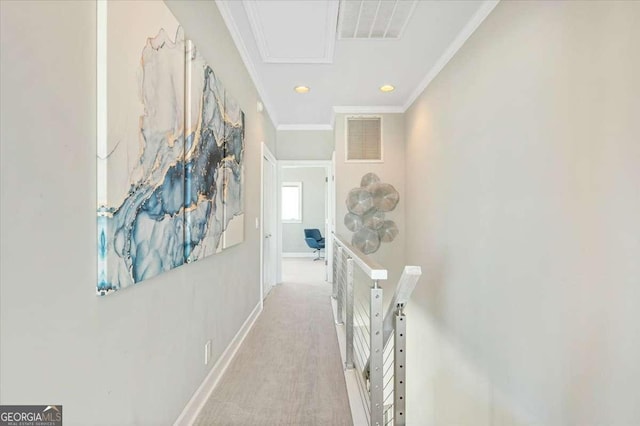 hallway with carpet, visible vents, baseboards, and crown molding