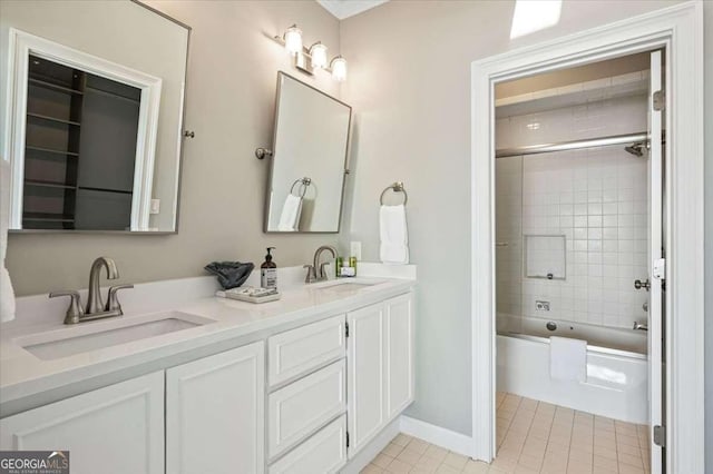 full bath with shower / tub combination, double vanity, a sink, and tile patterned flooring