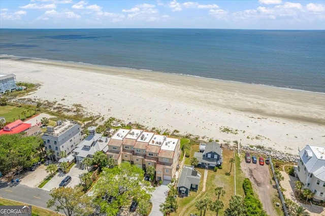 bird's eye view with a water view and a beach view