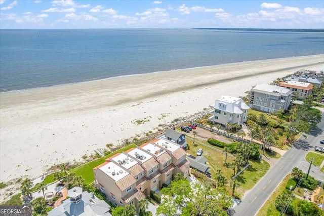 bird's eye view with a water view and a beach view