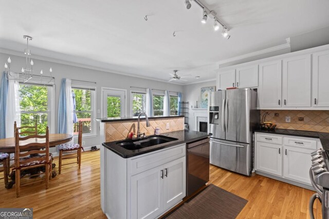 4016 Upland Trce, Marietta, GA 30066 - kitchen with track lighting, white cabinetry, appliances with stainless steel finishes, a sink, and dark countertops