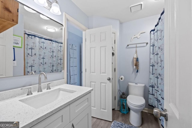 4016 Upland Trce, Marietta, GA 30066 - bathroom featuring a shower with shower curtain, vanity, toilet, visible vents, and wood finished floors