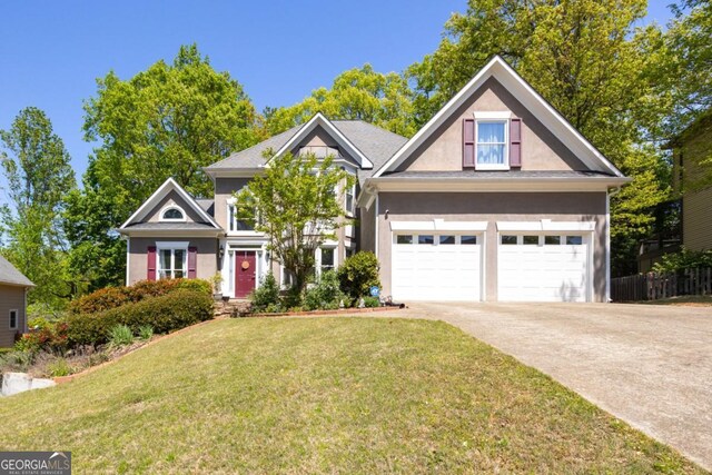 4016 Upland Trce, Marietta, GA 30066 - view of front of house featuring driveway, stucco siding, and a front lawn