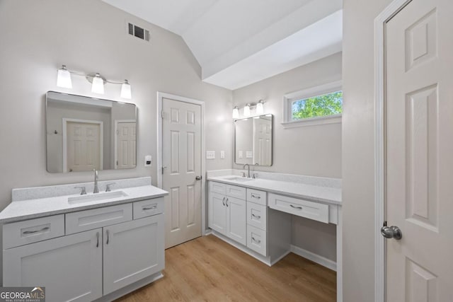4016 Upland Trce, Marietta, GA 30066 - bathroom with a sink, two vanities, wood finished floors, and lofted ceiling
