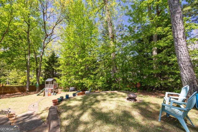 4016 Upland Trce, Marietta, GA 30066 - view of yard featuring fence, a playground, and an outdoor fire pit