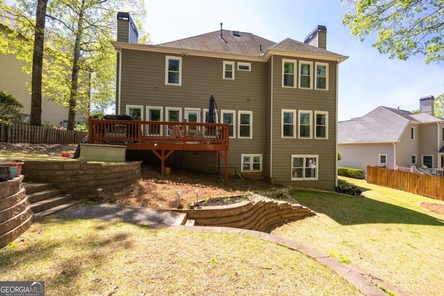 4016 Upland Trce, Marietta, GA 30066 - rear view of house with fence, a yard, a deck, and a chimney