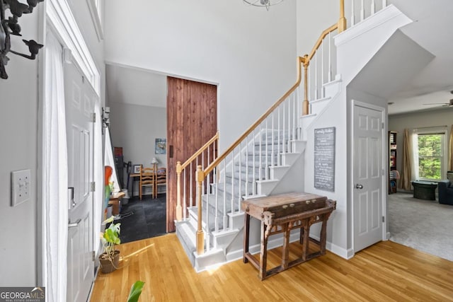 4016 Upland Trce, Marietta, GA 30066 - foyer entrance with baseboards, a ceiling fan, stairway, wood finished floors, and a towering ceiling