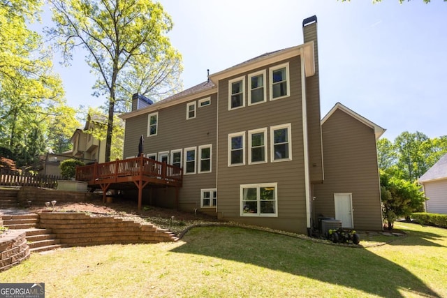 4016 Upland Trce, Marietta, GA 30066 - back of property with a chimney, a wooden deck, and a yard