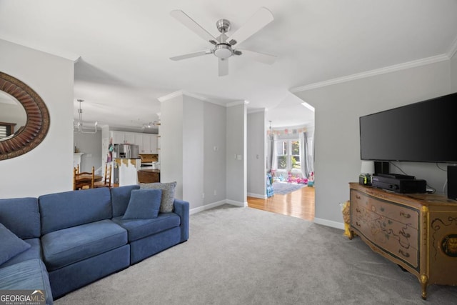 4016 Upland Trce, Marietta, GA 30066 - living room featuring light carpet, ceiling fan with notable chandelier, baseboards, and ornamental molding