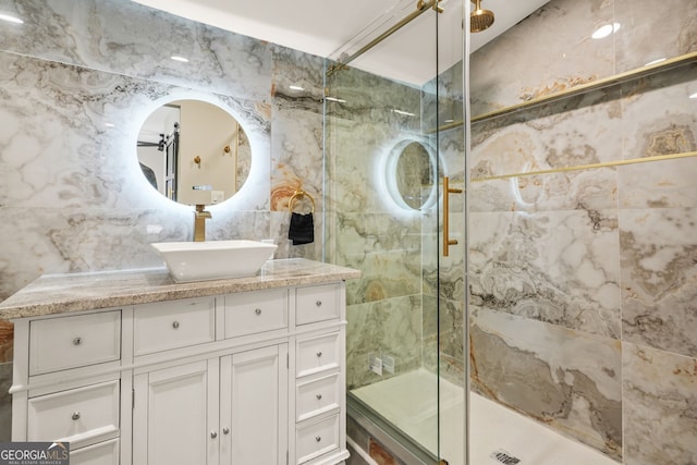 full bath featuring vanity, tile walls, and a stall shower