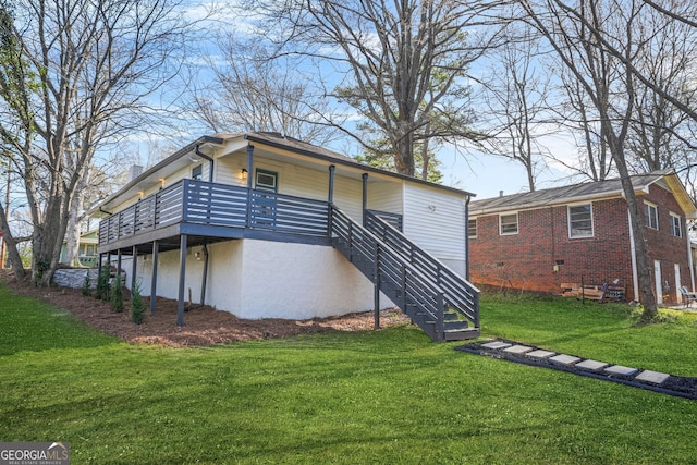 back of property with a yard and stairway