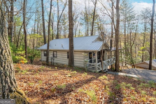 view of side of property with metal roof