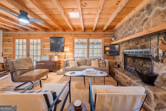 living area featuring a ceiling fan, wood walls, beamed ceiling, hardwood / wood-style floors, and wooden ceiling