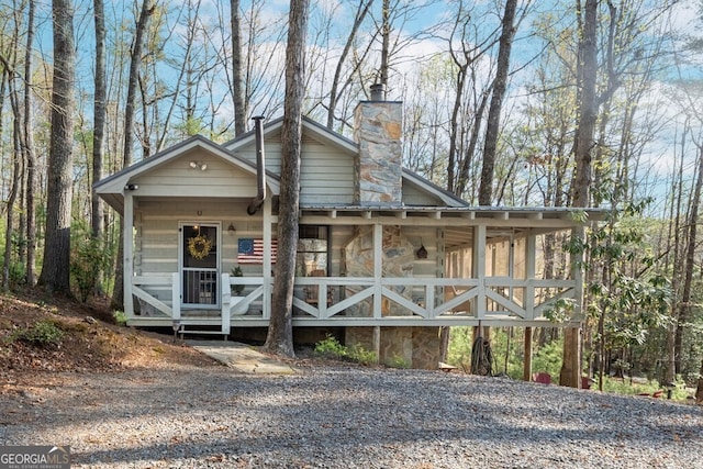 view of front of property with a porch and a chimney