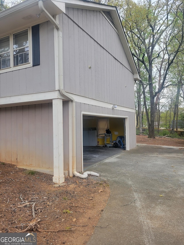 5251 Greenpoint Dr, Stone Mountain, GA 30088 - view of side of property with asphalt driveway and a garage
