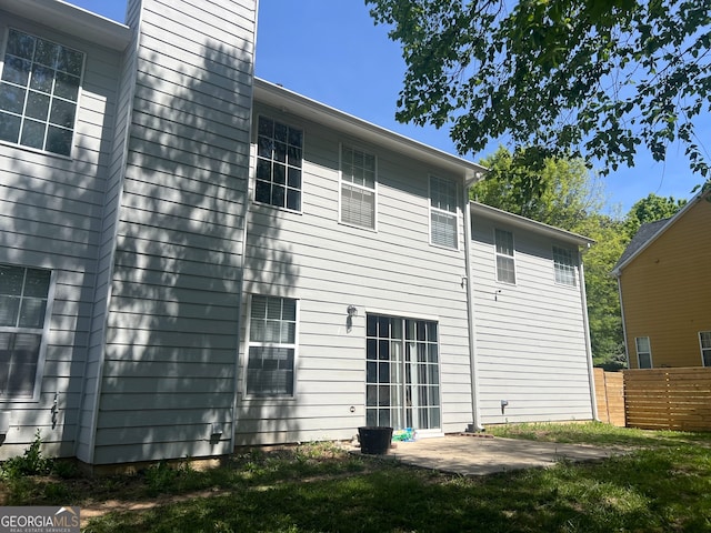 345 S Magnolia Walk SE, Atlanta, GA 30349 - rear view of property with a patio and fence