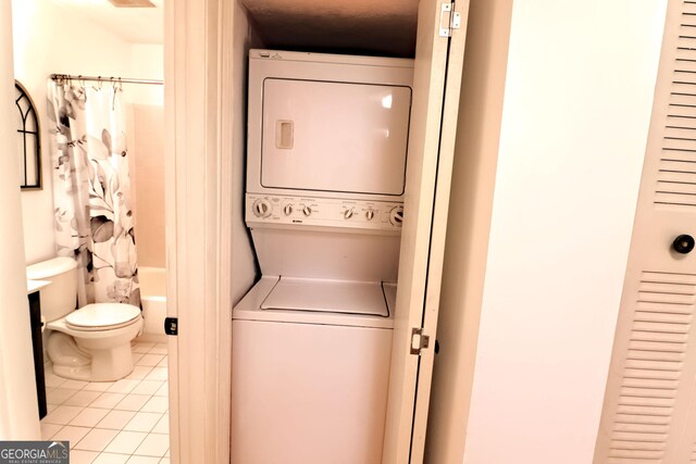 1181 Church St Unit D, Decatur, GA 30030 - washroom with stacked washer / dryer and light tile patterned floors