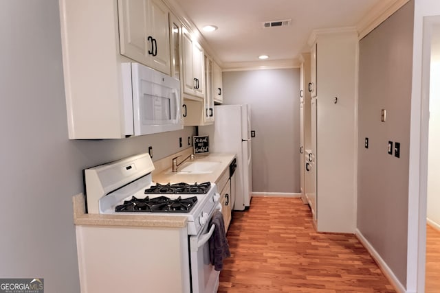 1181 Church St Unit D, Decatur, GA 30030 - kitchen featuring white appliances, light wood finished floors, light countertops, recessed lighting, and white cabinets
