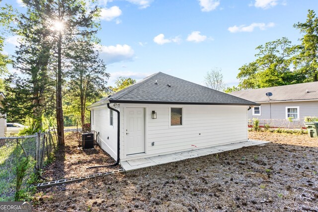 849 Wood St NW, Atlanta, GA 30318 - rear view of house with cooling unit, a shingled roof, and fence