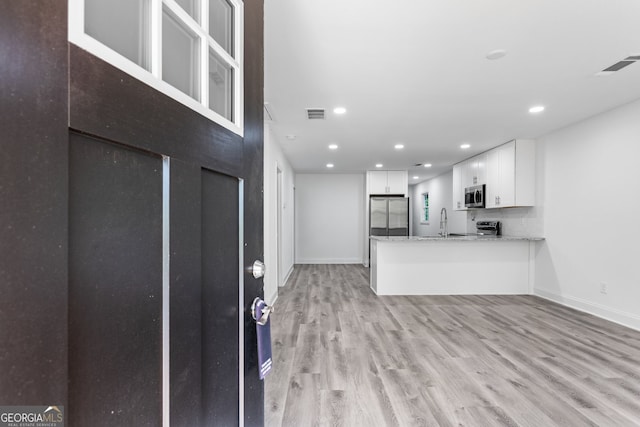 849 Wood St NW, Atlanta, GA 30318 - interior space featuring white cabinets, stainless steel appliances, visible vents, and a sink