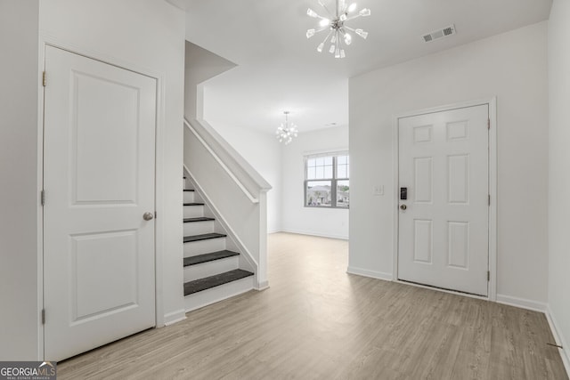 4740 Alford Commons, Cumming, GA 30028 - entryway with a chandelier, stairs, and wood finished floors