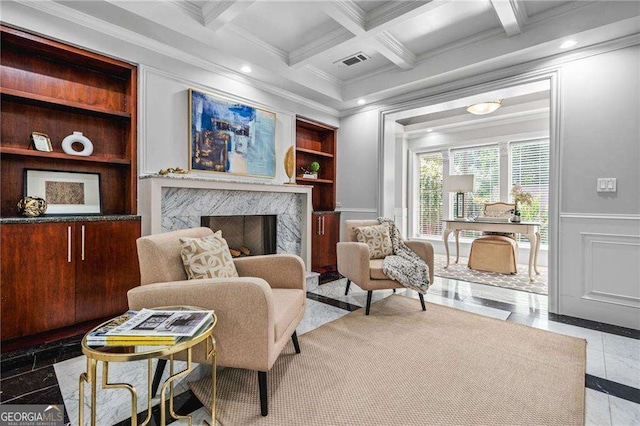 sitting room featuring visible vents, built in features, beamed ceiling, crown molding, and a fireplace