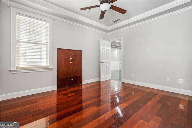 unfurnished bedroom featuring crown molding, wood finished floors, and multiple windows