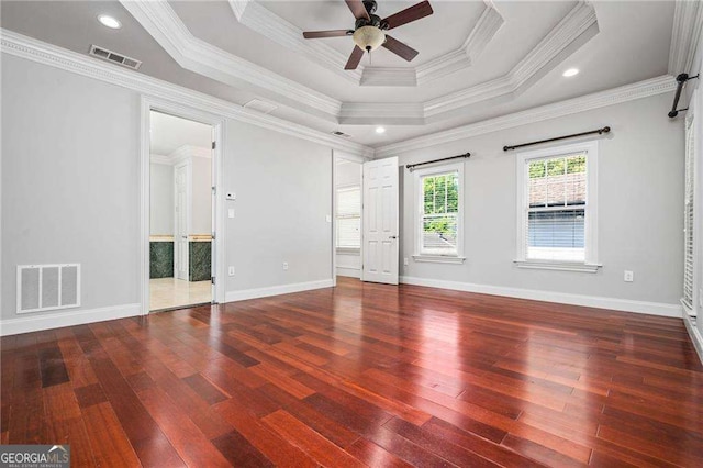 empty room with hardwood / wood-style floors, visible vents, and ceiling fan