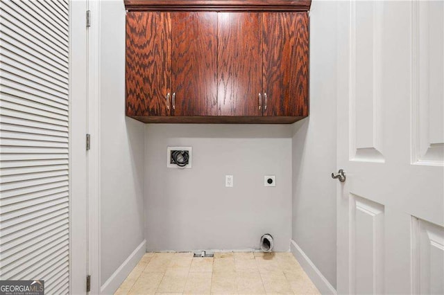 washroom featuring electric dryer hookup, baseboards, hookup for a washing machine, and cabinet space
