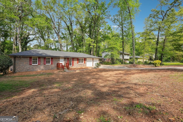 single story home featuring brick siding and driveway