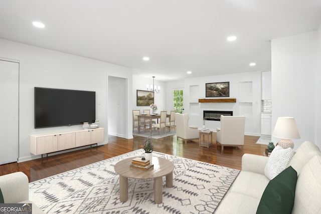 living area featuring recessed lighting, wood finished floors, baseboards, a glass covered fireplace, and a notable chandelier
