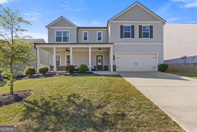 traditional home featuring a front lawn, driveway, a porch, a ceiling fan, and an attached garage