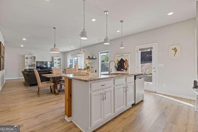 kitchen featuring recessed lighting, white cabinets, stainless steel dishwasher, and light wood-type flooring