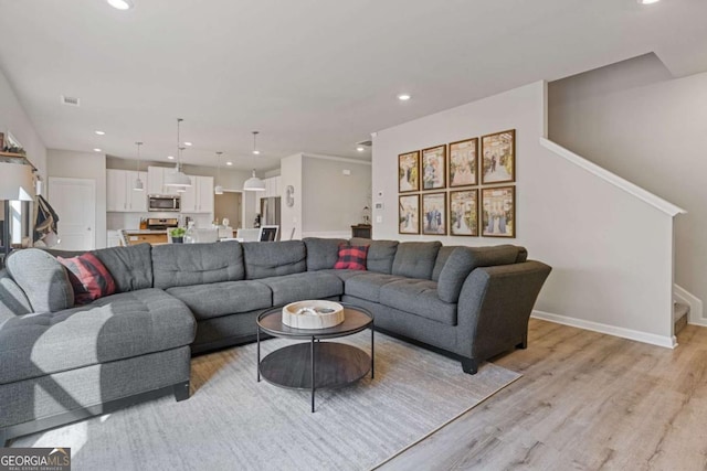 living room featuring recessed lighting, stairway, light wood finished floors, visible vents, and baseboards