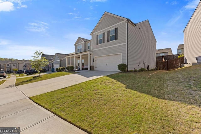 traditional-style house with a residential view, driveway, fence, an attached garage, and a front yard