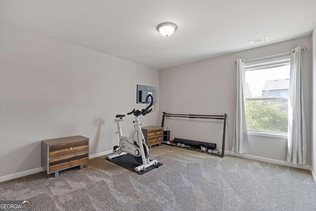 exercise area featuring visible vents, carpet flooring, and baseboards