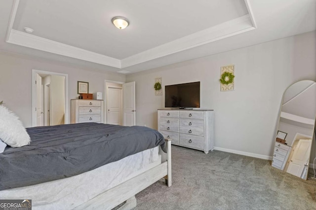 carpeted bedroom featuring baseboards, crown molding, and a tray ceiling