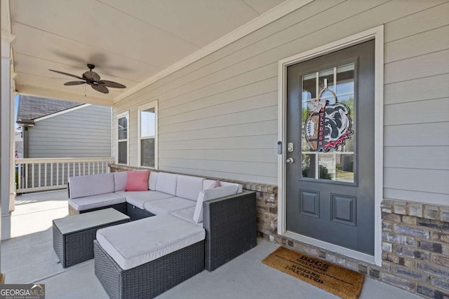 view of exterior entry with stone siding, outdoor lounge area, and a ceiling fan