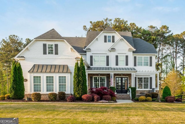 984 Hunter Way, Milton, GA 30004 - view of front of house featuring a standing seam roof, a front yard, metal roof, and french doors