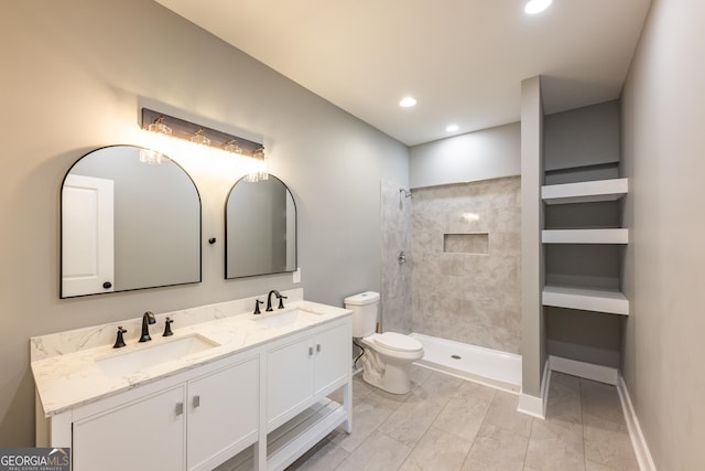710 Avalon Rd, Thomaston, GA 30286 - bathroom with toilet, double vanity, a tile shower, recessed lighting, and marble look tiles
