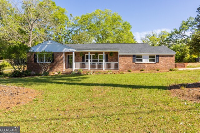 710 Avalon Rd, Thomaston, GA 30286 - ranch-style home with a porch, brick siding, and a front yard