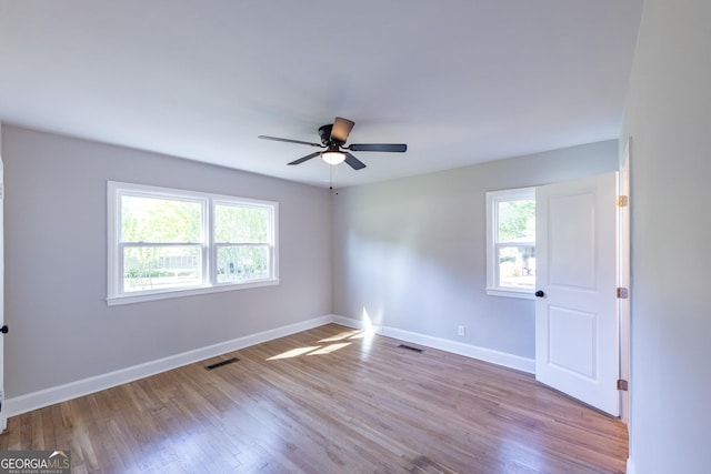 710 Avalon Rd, Thomaston, GA 30286 - unfurnished room with healthy amount of natural light, wood finished floors, a ceiling fan, and baseboards