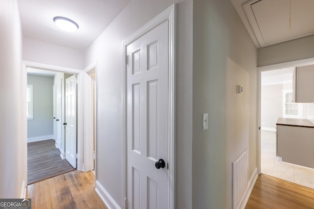 710 Avalon Rd, Thomaston, GA 30286 - corridor featuring attic access, light wood-style floors, and baseboards