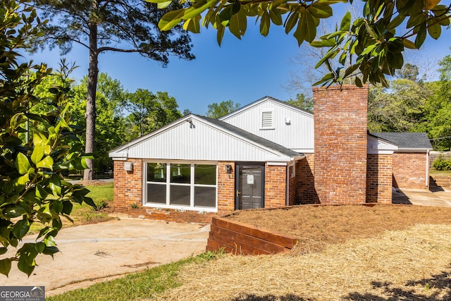 710 Avalon Rd, Thomaston, GA 30286 - view of front of house featuring a patio, brick siding, and a chimney