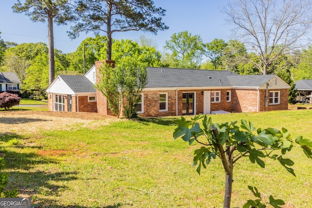 710 Avalon Rd, Thomaston, GA 30286 - back of property with brick siding, a lawn, a chimney, and roof with shingles