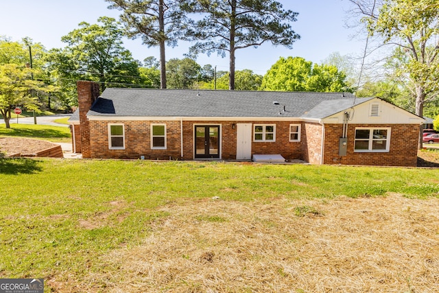 710 Avalon Rd, Thomaston, GA 30286 - rear view of house with french doors, a chimney, a lawn, and brick siding