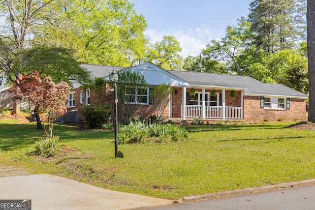 710 Avalon Rd, Thomaston, GA 30286 - ranch-style house featuring a porch, brick siding, and a front lawn