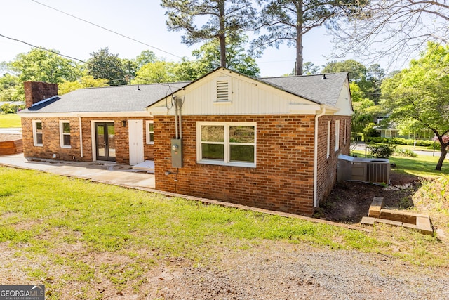 710 Avalon Rd, Thomaston, GA 30286 - view of front of home featuring french doors, a chimney, a front lawn, brick siding, and a shingled roof